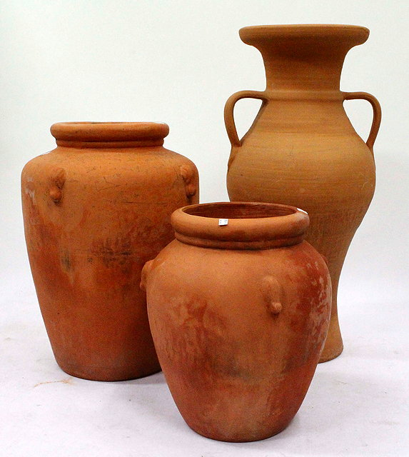 THREE LARGE TERRACOTTA POTS the largest with twin handles 87cm