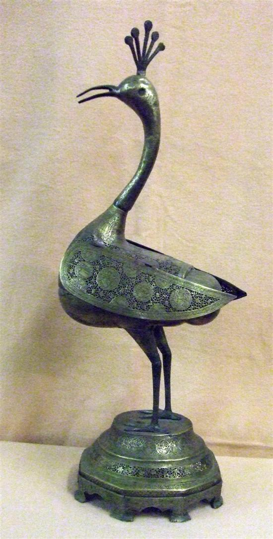 AN EASTERN BRASS MODEL of a bird on a circular