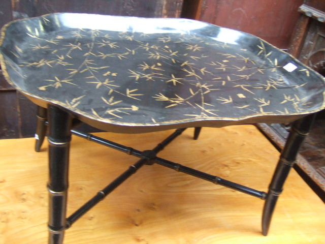 A pair of black lacquer papier mache trays with gilt
