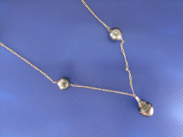 A 14ct gold fancy link necklace with seven baroque Tahitian