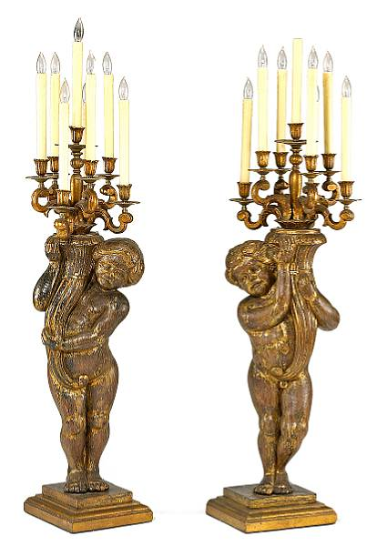 A pair of Baroque style parcel gilt wood figural seven