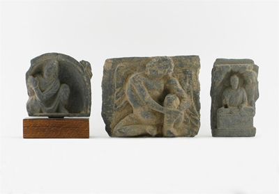 Three Gandh ra grey schist carvings of seated figures one