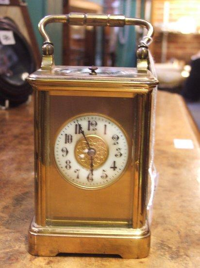 A FRENCH BRASS REPEATER CARRIAGE CLOCK circular white enamel dial