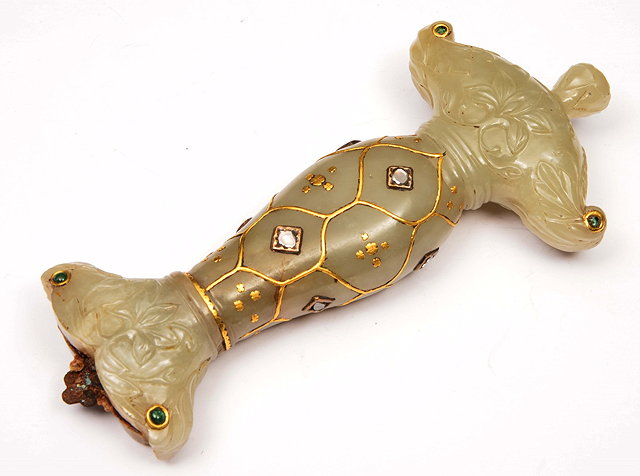 A MUGHAL JADE DAGGER HILT studded with uncut diamonds rubies