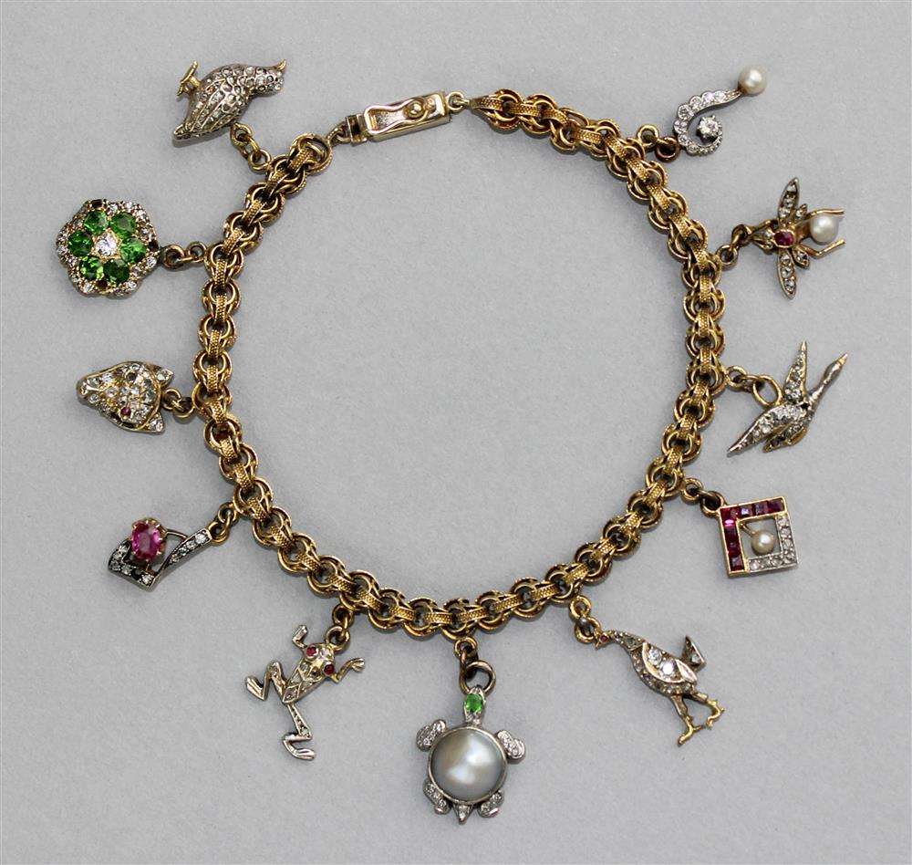 14K YELLOW GOLD CHARM BRACELET WITH ELEVEN CHARMS the charm