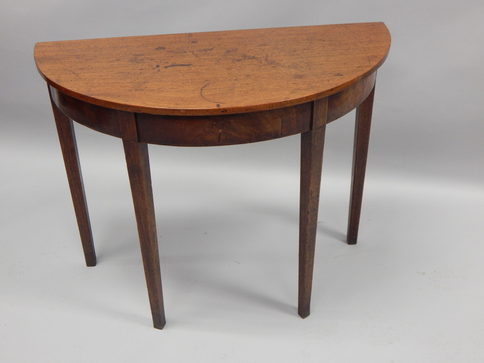 An early 19thC mahogany half round side table on square