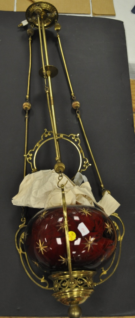 Converted gas chandelier with cranberry and gold star shade three