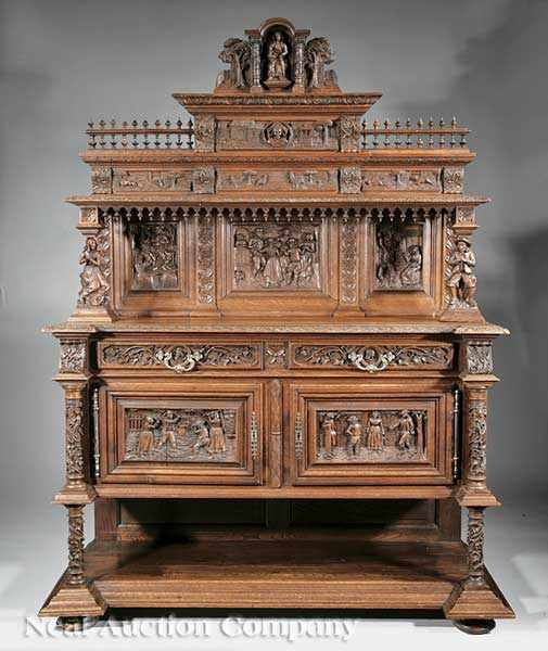 A Monumental Continental Renaissance Revival Highly Carved Walnut Dining Suite