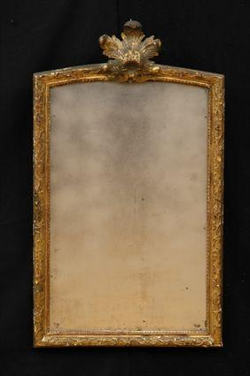 REGENCE STYLE CARVED GILTWOOD MIRROR The arched plate within narrow