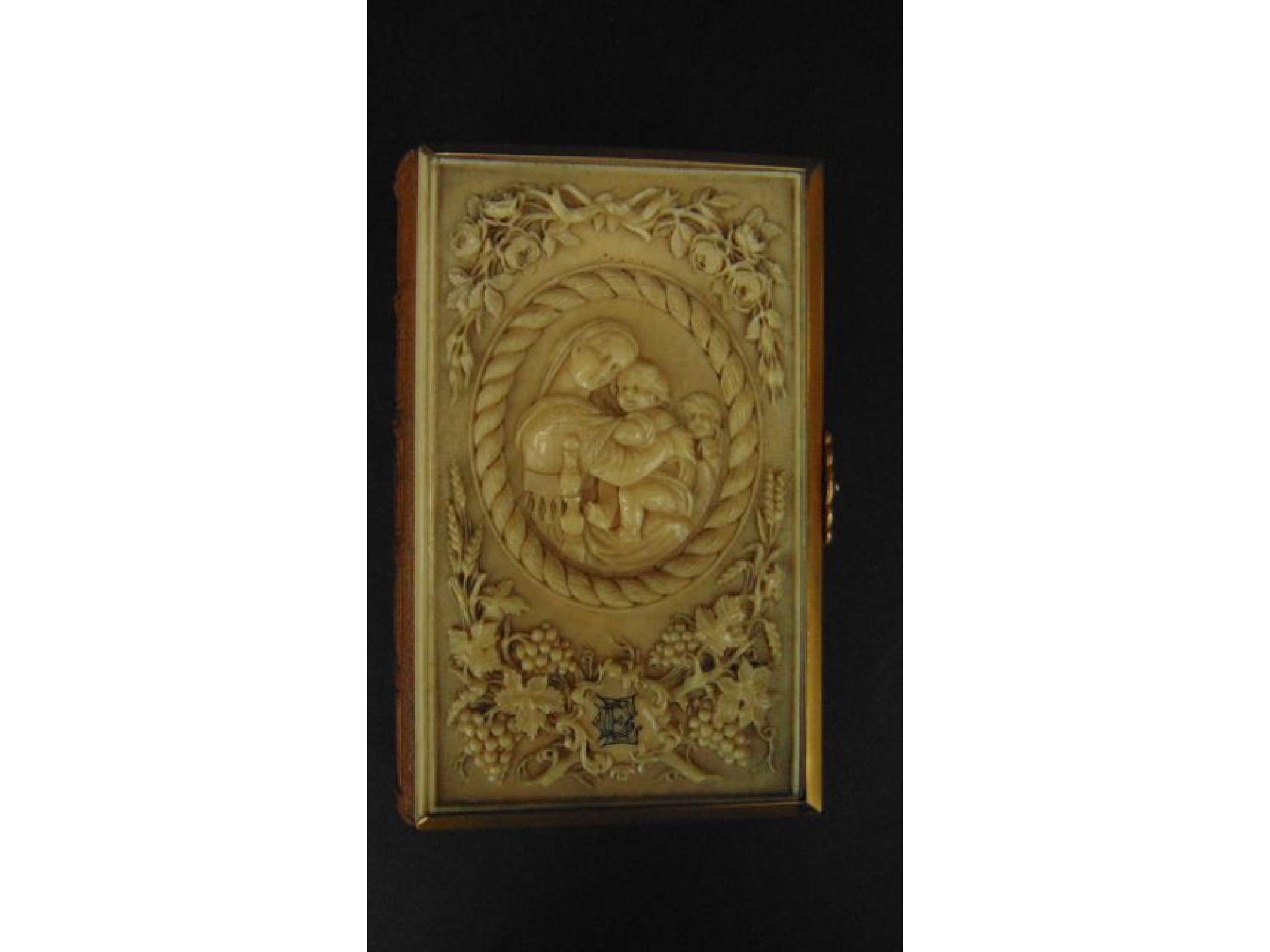 A carved ivory brass and leather bound copy of The