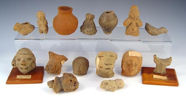 PRECOLUMBIAN ECUADORIAN CARVINGS Assorted artifacts including dogs head faces idols