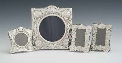Four Sterling Silver Clad Picture Frames with Stands Each repousse