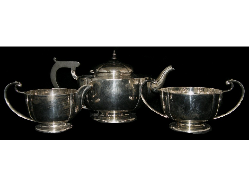 Three piece tea service of lobed form and with scrolling