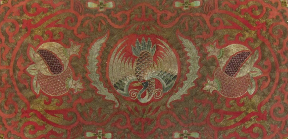A Chinese Qing period silk panel raised and centred by