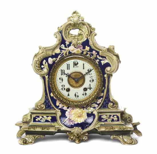 A German Ceramic Mantel Clock the cartouche form floral decorated