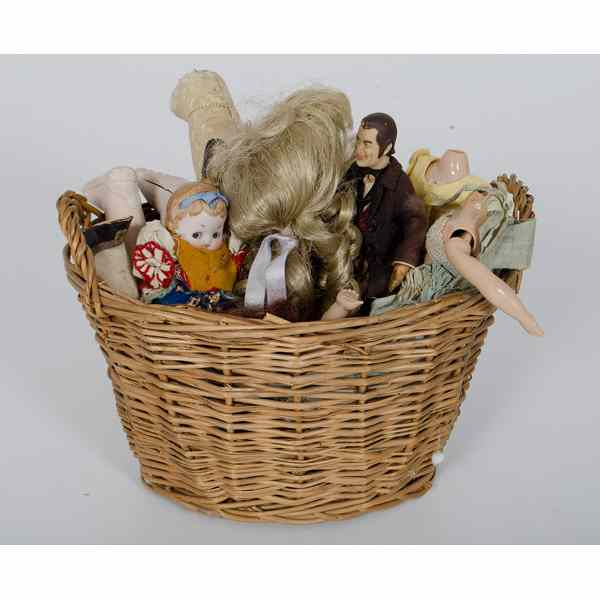 Assorted Doll Parts Basket with various doll pieces including three