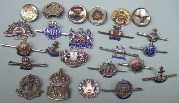 A collection of twenty four mostly military sweetheart brooches and