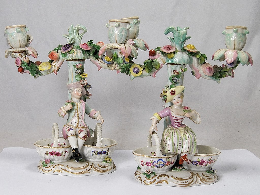 A pair of Dresden porcelain candelabra with floral encrusted stems
