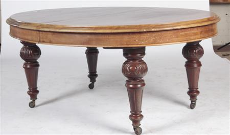 A Victorian mahogany extending dining table the moulded oval top