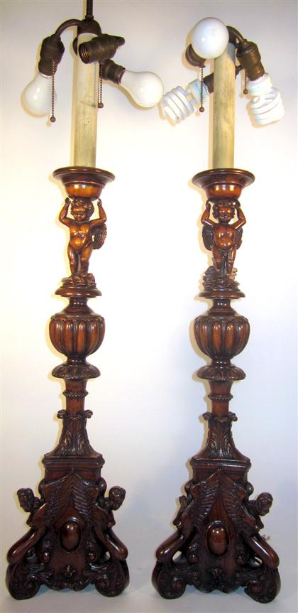 Pair of Baroque style carved walnut candlesticksEach with a winged