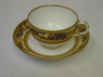 A ROYAL WORCESTER PORCELAIN CUP AND SAUCER painted with bands