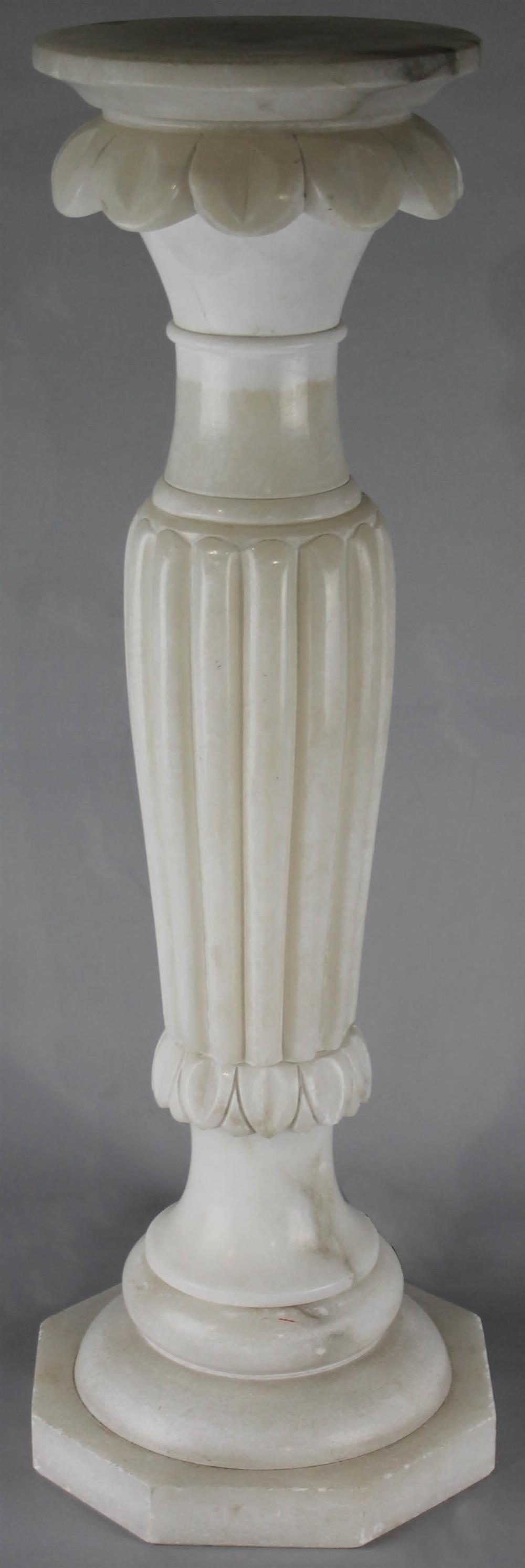 ALABASTER LIGHTED PEDESTAL carved with leaf tips above a reeded