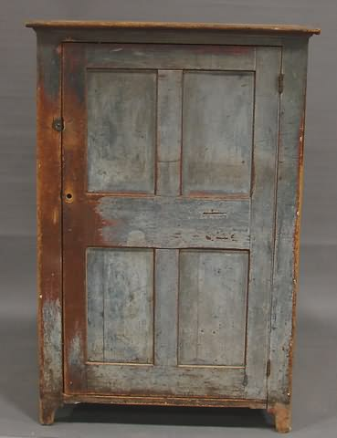 Overhanging top paneled door hinges on right shelved interior bracket
