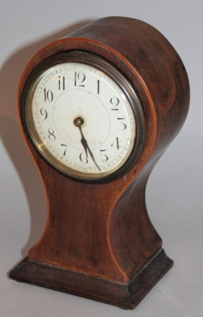 An Edwardian mahogany balloon clock the 8 5cm dia dial