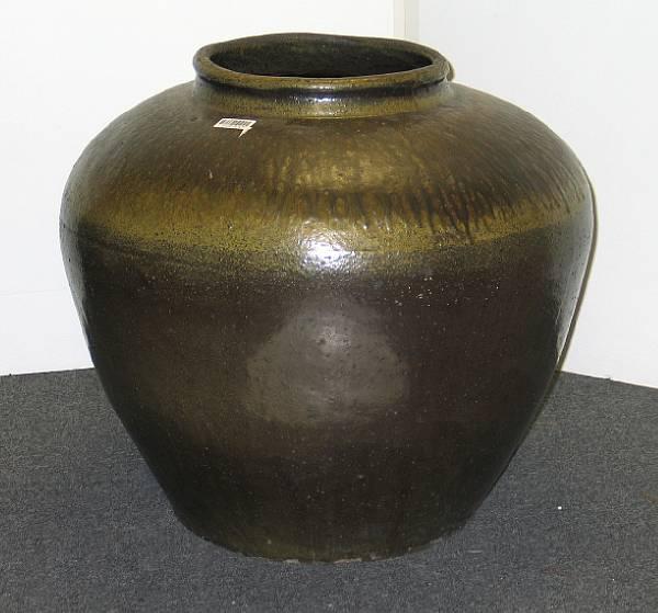 A massive glazed pottery storage jar Possibly of Chinese origin
