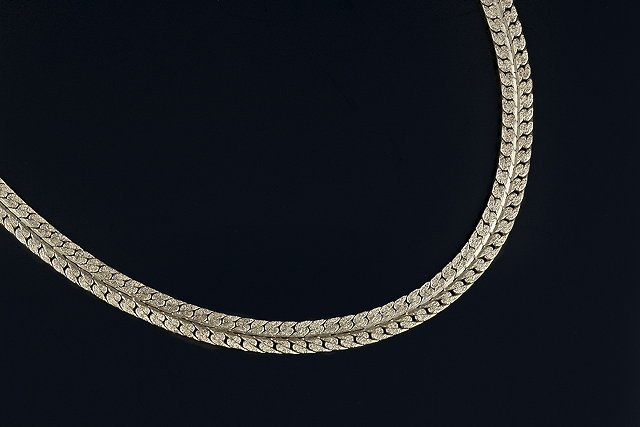 A yellow precious metal fancy link chain of stylised flattened