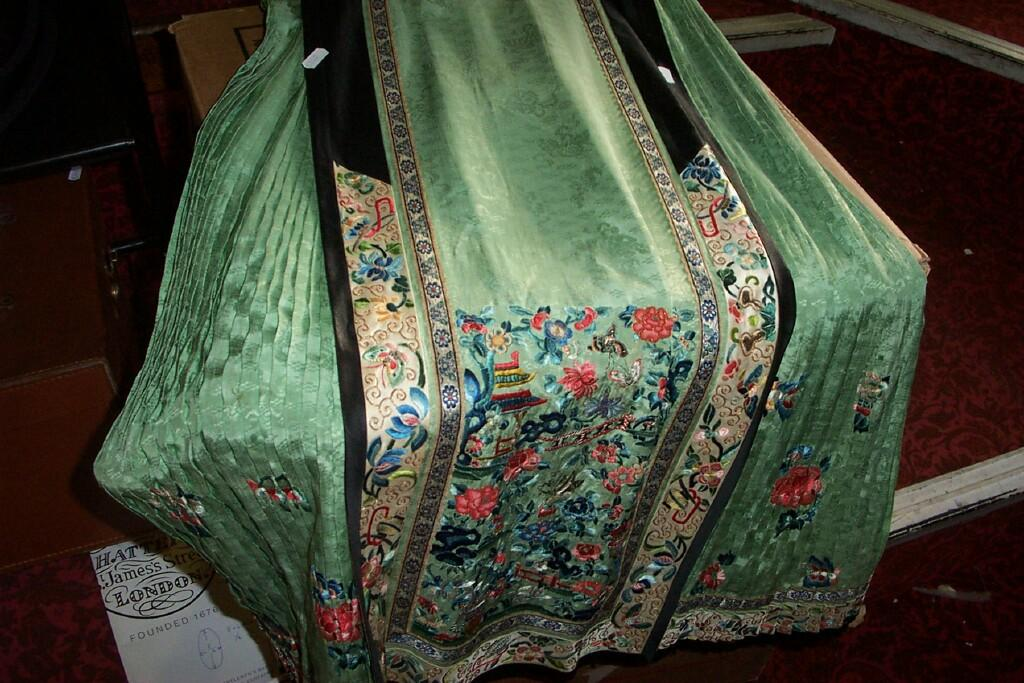 An early 20th century Chinese green silk skirt with polychrome
