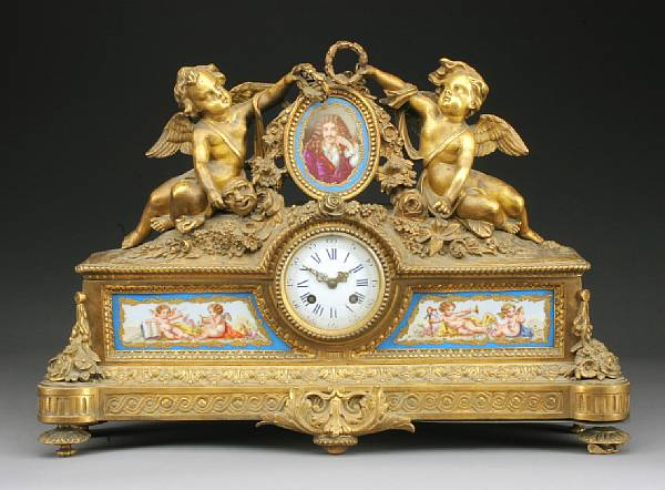 A Louis XV style porcelain mounted gilt bronze mantel clock