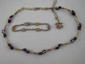 A white metal tests silver necklace with amethyst beads approx