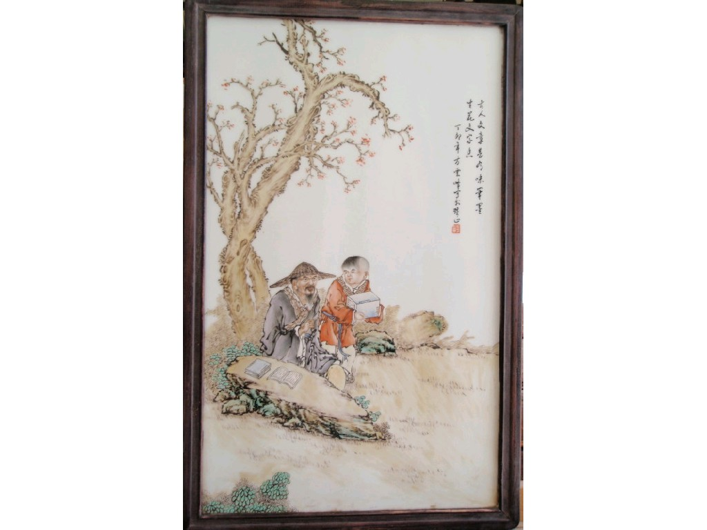 A Chinese porcelain plaque depicting teacher and pupil in landscape