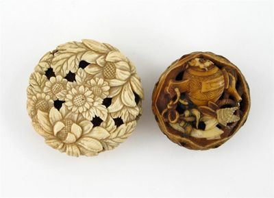 Two Japanese ivory netsukes one a manju netsuke pierced and