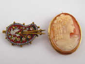 A carved shell cameo brooch in a yellow metal tests