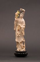 Carved Ivory Figure with Flowers Delicately carved ivory figure depicts