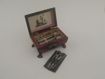 A small 19th century continental red leather sewing box on