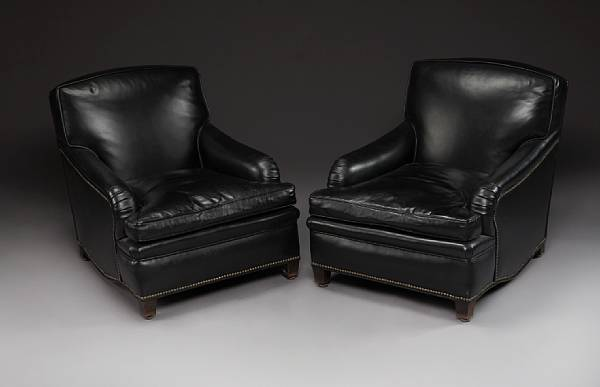 A pair of Art Deco black leather rolled arm club