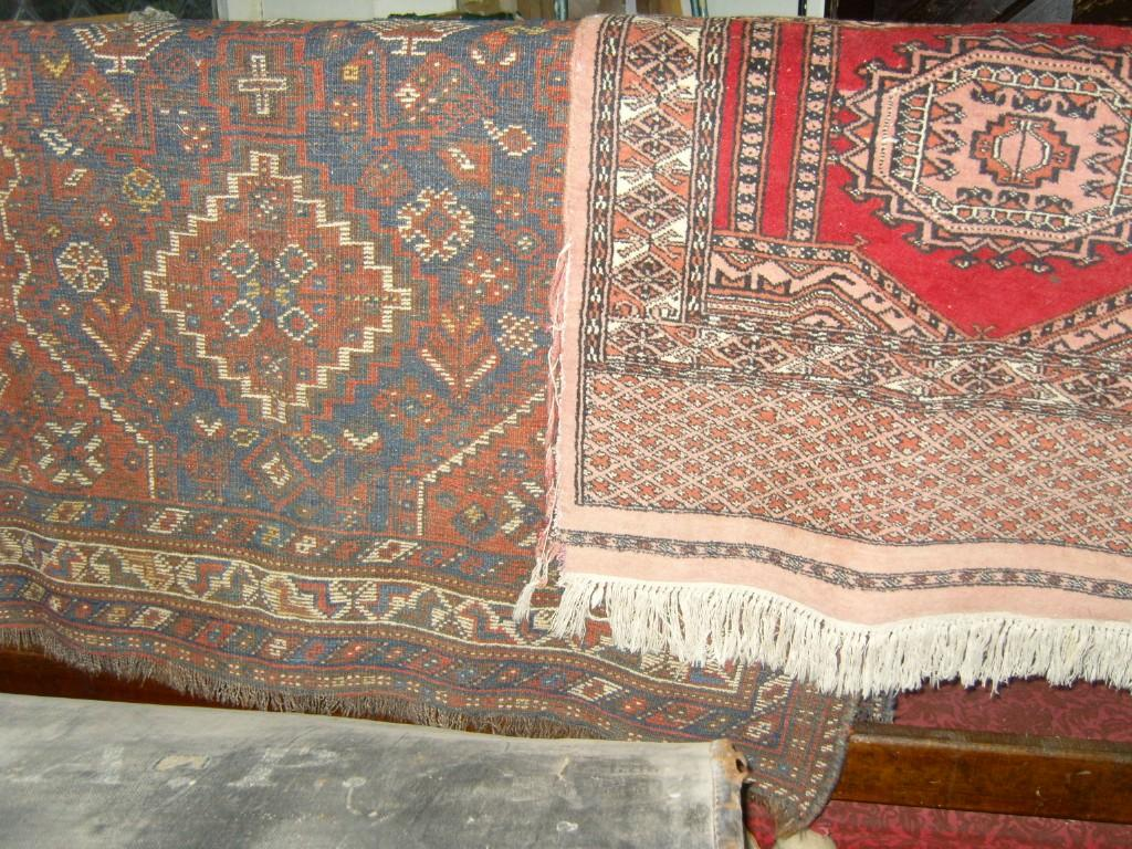 A red ground eastern wool rug with stylised floral decoration