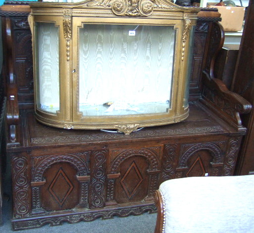 A 19th century oak box settle with high carved wing