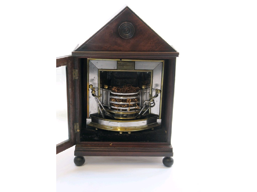 A MINIATURE REGENCY POLISHED STEEL AND BRASS FIREPLACE bearing a
