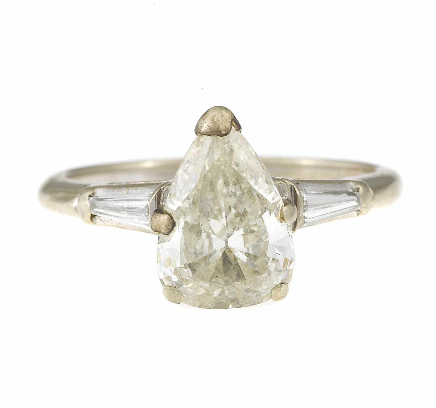 A diamond solitaire ring central pear shaped diamond weighing approximately