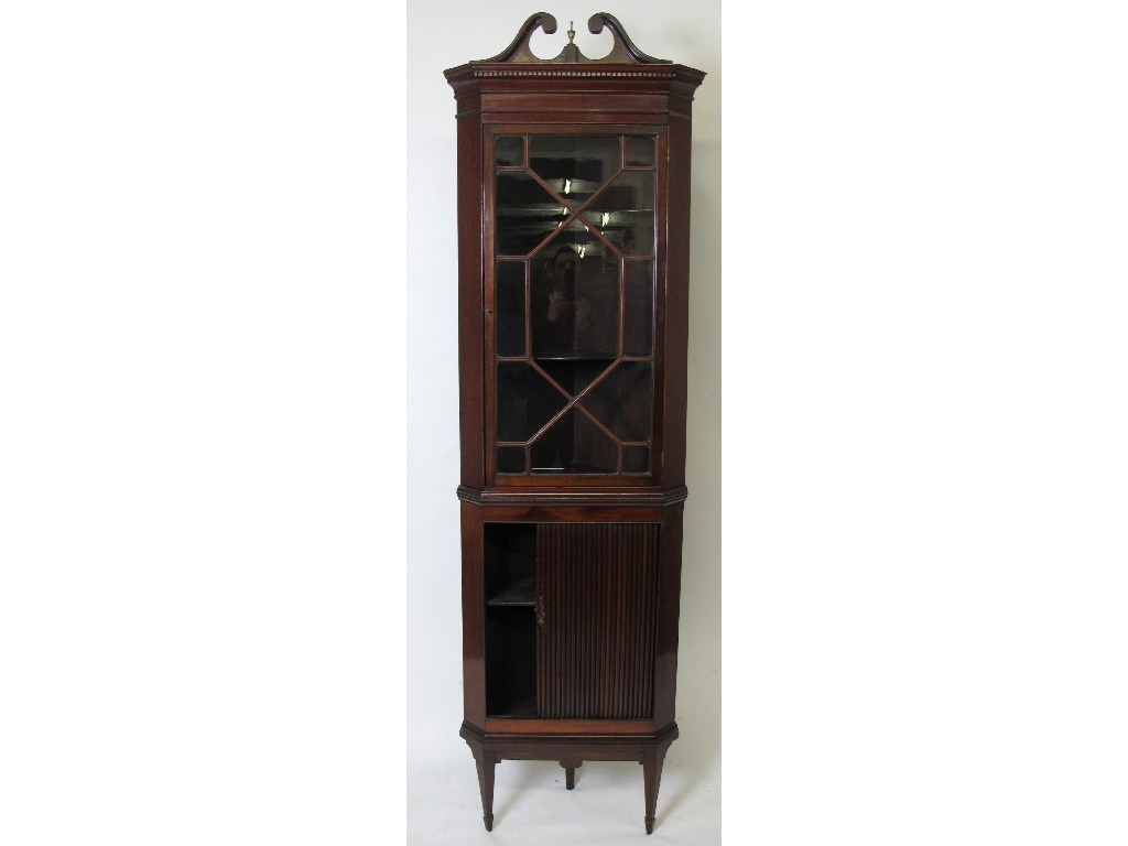 An Edwardian mahogany corner cabinet on stand the top with