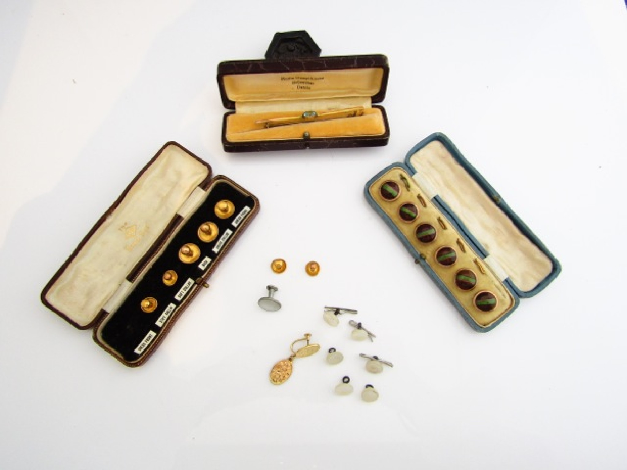A 9ct gold bar brooch centred with a pale blue