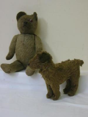 An early 20th century English teddy bear straw filled covered