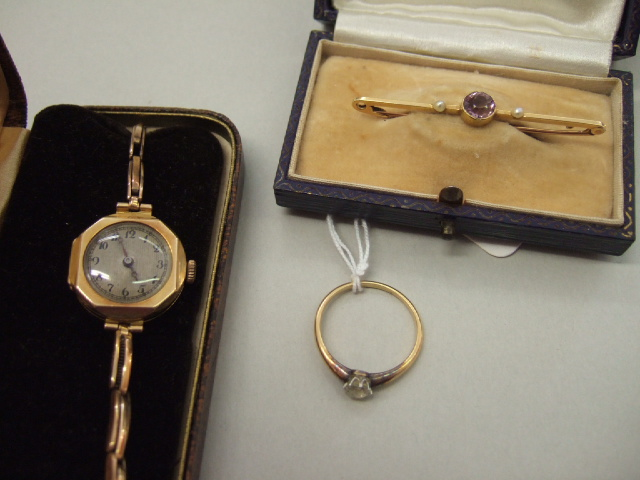 A gold and diamond set single stone ring claw set