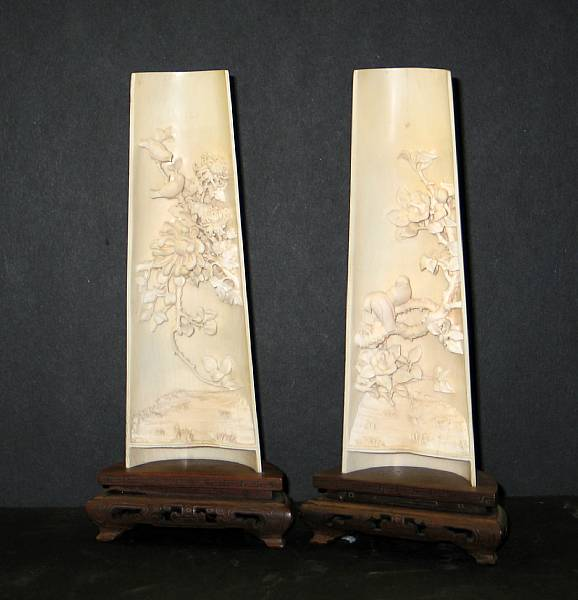 A pair of carved ivory tusk sections Each tusk section