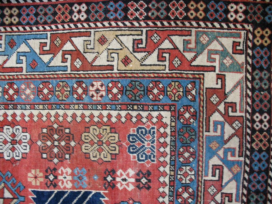A SHIRVAN AKARAGASHLI RUG the brick red ground with a