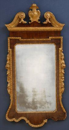 GEORGE II MAHOGANY AND PARCEL GILT MIRROR The swan neck